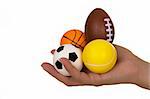 Feminine hand holding miniaturized rubber sport balls over white background