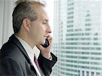 Businessman by the window talking on the phone