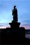 Statue on the Charles Bridge, in Prague, Czech Republic in the early evening.