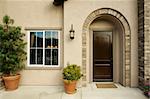 A newly constructed, modern american home doorway and patio.