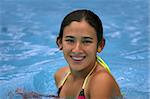 Happy teen girl with braces in the pool