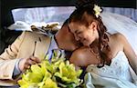 Kiss of a newly-married couple in car