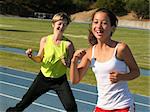 Mother and daughter exercising on a blue racetrack