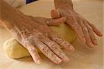 Woman hands work into dough