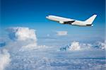 Large airliner climbing above the clouds shortly after take-off