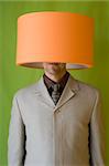 a businessman with a lamp in his head and holding the lamp