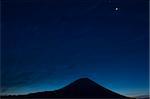 Silhouette of Mt. Fuji against a dark blue sky