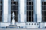 An old building with golden statues in Paris, France.  Blue tone.