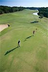Aerial view of mid adult Caucasian man and woman playing golf at Bald Head Island, North Carolina.