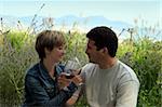 Young couple having picnic with wine