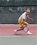 Middleage man playing tennis