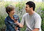 Young couple having picnic with wine