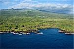 Aerial of Maui, Hawaii coastline with mountains in background.