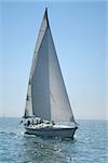 The large, beautiful yacht in the light-blue sea. A fresh wind and pleasant movement