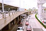 Travelers getting taxis at arrival area of airport