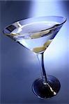 Martini in shaft of light with blue background