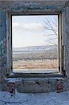 window in the old abandoned building with view on the forest, river Volga and mountains on the other side.