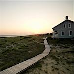Coastal beach house with wooden boardwalk at  Bald Head Island, North Carolina.