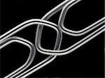 Two linked paperclips on a black background