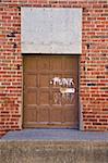 Red overhead door with graffitti