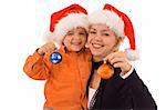 Woman and boy with santa hats holding christmas baubles - isolated