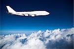 Jumbo jet in level flight high above clouds