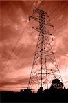 Silhouettes of power lines and a tower