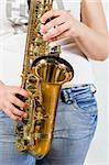 Young saxophone player with white t-shirt and jeans.