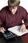 male accountant working with papers and calculator