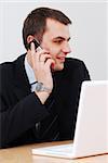 Young businessman talking on the phone, smiling