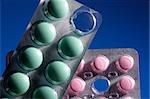 Pink and green tablets on a dark blue background