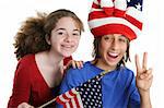 A teen boy and girl wearing a patriotic hat and waving an American flag at school or watching a parade go by.