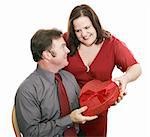 Woman giving her husband valentine chocolate.  Isolated on white.