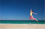 beautiful woman jumping in the beach