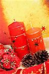 Christmas decoration with balls and candles, over colour background. Shallow DOF
