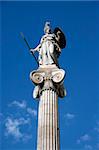 the statue of goddess athena on a tall corinthian pillar in front of the university of athens greece on total blue sky background