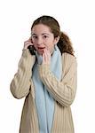 A cute teen girl sharing juicy gossip over the phone.  Isolated.
