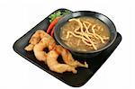 A bowl of Chinese hot & sour soup with crunchy noodles and tempura fried fantail shrimp.  Isolated with clipping path