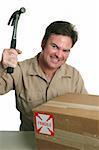 A postal worker getting ready to smash a fragile package with a hammer.