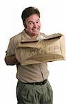 A guilty looking delivery man holding a smashed package.
