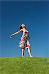 Happy woman having fun on a beautiful green meadow