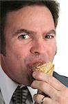 A closeup of a businessman eating ice cream.