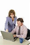 A business team working on the computer.  The female is in charge.  Isolated on white.