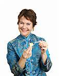 A pretty woman in a chinese blouse happy with the fortune she just got in her cookie.  Isolated on white.