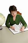 A middle aged student, or librarian, doing research in the library.  Isolated on white.  Note to inspector: Texture of the shirt may resemble artifacting.