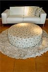 White sofa with two pillows and floral design