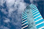 Blue glass business building against blue sky