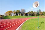 racetrack for runners and a speaker in the grass