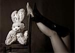 Beautiful legs of the woman and a toy hare