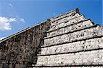Wall of Ancient Mayan Pyramid at Chichen Itza on the blue sky. Chichen Itza in the Yucatan was a Maya city and one of the greatest religious center and remains today one of the most visited archaeological sites
